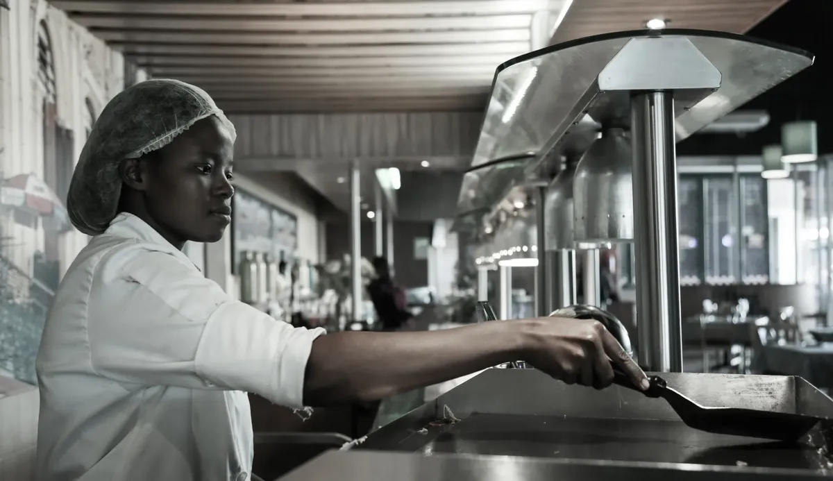Experienced chef preparing meals in a commercial kitchen in Kempton Park, South Africa.