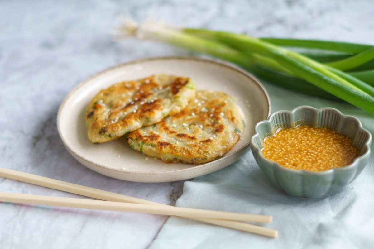 Traditional Korean pancake preparation in kitchen